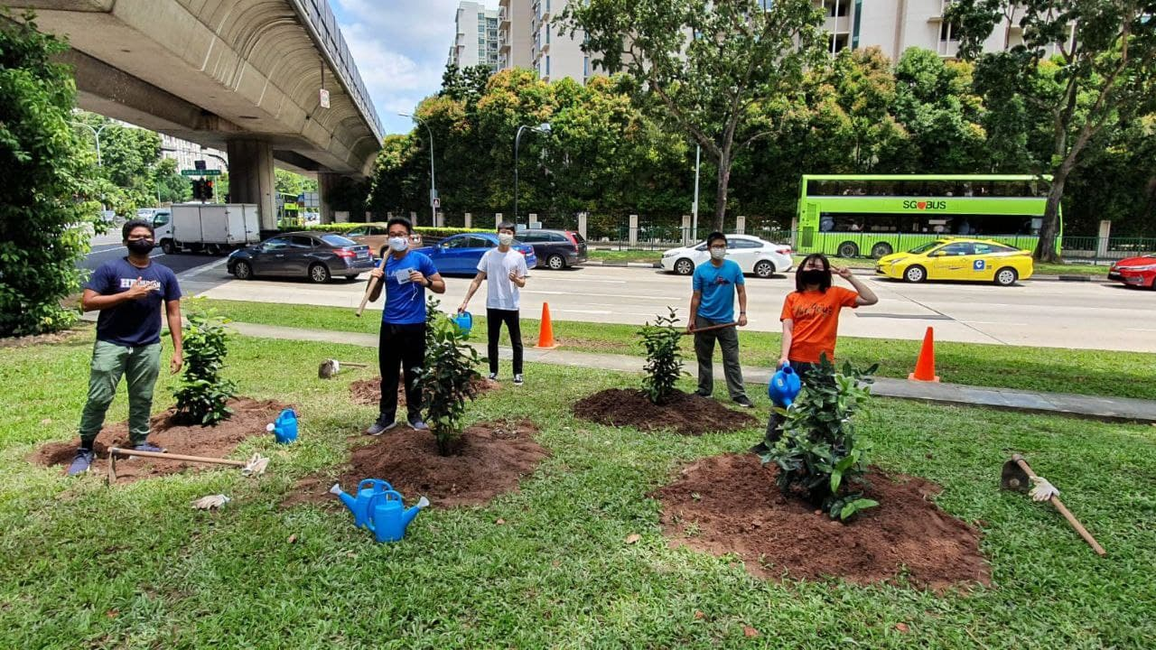 See Toh Ee Kin (second from right) and his friends get acquainted with the tree planting process.