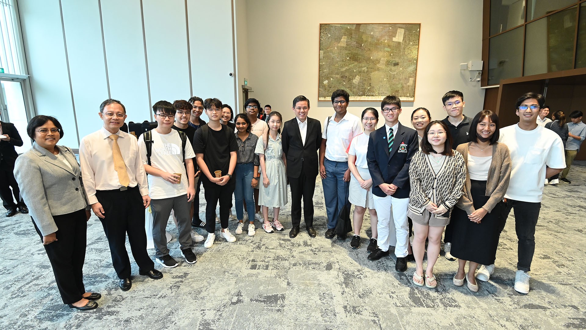 NUS Professor Tulika Mitra, Provost's Chair Professor of Computer Science and Vice Provost of Academic Affairs (extreme left) and NUS Acting Provost Professor Bernard Tan (second from left) joined students to interact with Minister for Education Chan Chun Sing (ninth from right) at a reception held after the event.