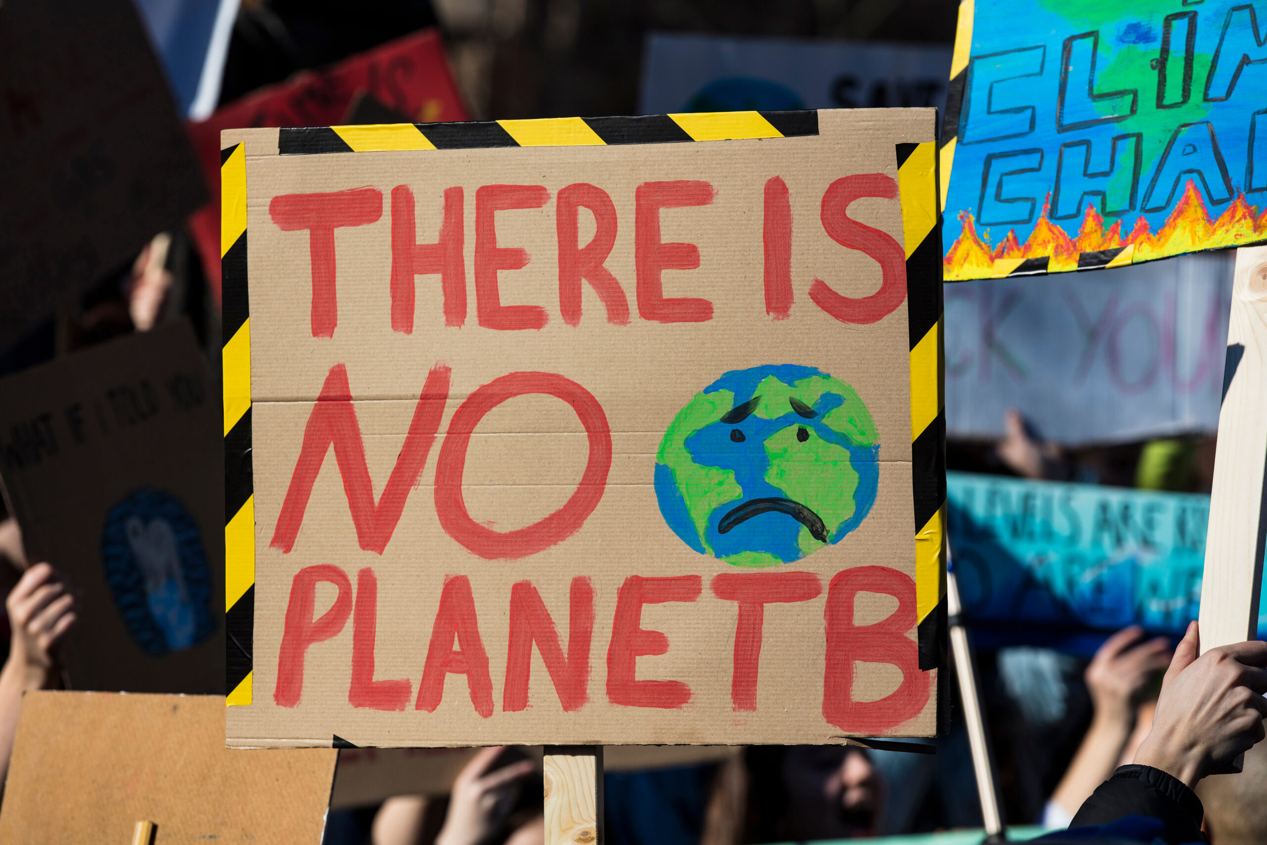 Protestors,Holding,Climate,Change,Banners,At,A,Protest